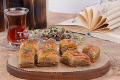 Glass of tea and traditional pistachio baklava on marble table